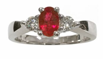 14k white gold oval shape ruby with two round diamonds on either side. 